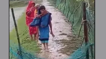 Cyclone Dana: ASHA Worker Carries Elderly Woman On Shoulder