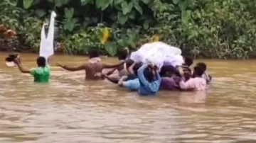 Villagers risk lives to carry bodies across flooded river in Koraput