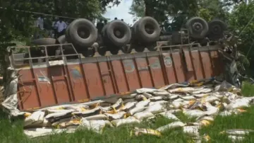 Driver narrowly escapes death as rice-laden truck overturns