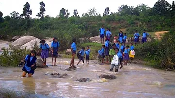 Children brave croc threat, waist-deep water to reach school