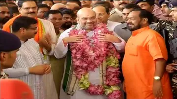 Shah gets two lotus garlands, one tagged with 21, another 147