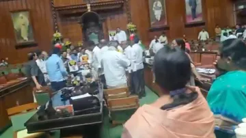 BJP leaders staged a protest inside the assembly demanding the resignation of the Excise Minister R.B. Timmapur, alleging rampant corruption in the excise department