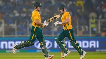 David Miller, right, and Tristan Stubbs run between the wickets during T20 World Cup 2026 cricket match in Ahmedabad on Sunday, Feb. 22, 2026.
