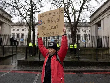 A protestor holds a placard during a demonstration against the proposed site of the new Chinese Embassy, outside Royal Mint Court, in London (Image/Reuters)