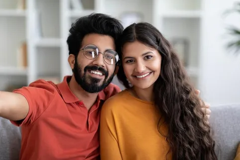 Closeup portrait of happy young indian couple taking selfie together at  home | Premium Photo