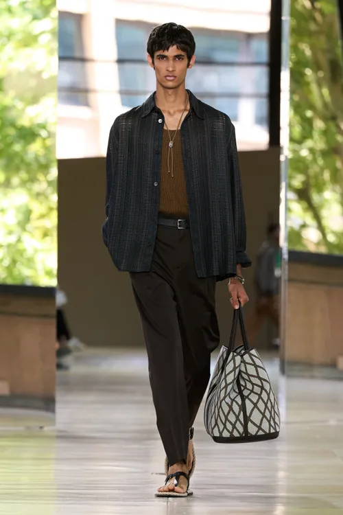 Image may contain Clothing Pants Adult Person Blazer Coat Jacket Accessories Bag Handbag Formal Wear and Suit