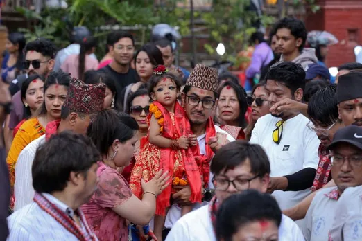 Aryatara Shakya is carried by her father as she is brought to the Taleju Bhawani Temple in Kathmandu Durbar Square, Nepal.