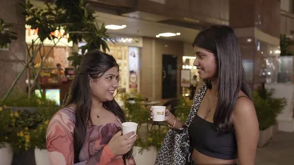 A couple of women holding cups

AI-generated content may be incorrect.