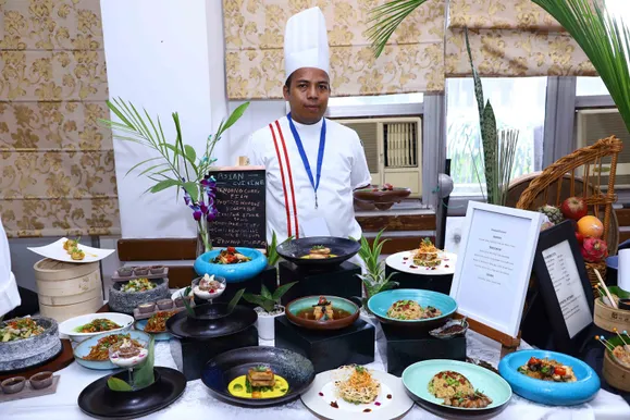 Chef showcasing a dish for the Master Chef Oriental Cuisine competition.