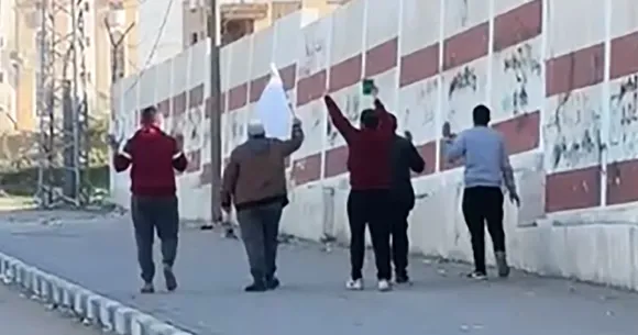 A group of Palestinian men waving a white flag is shot at, killing 1