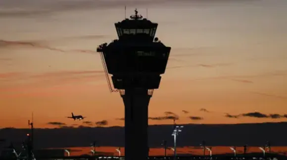 Bloomberg via Getty Images An air traffic control tower at sunset.