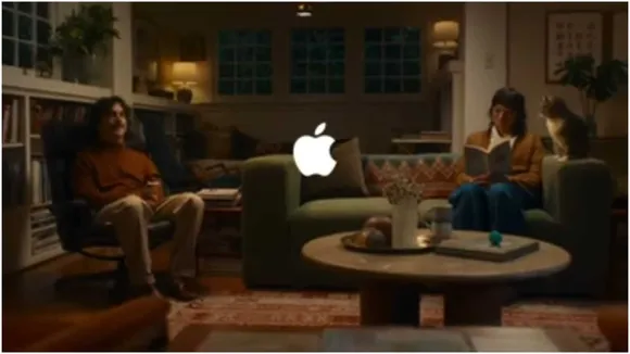 Apple Intelligence ad with an iPhone 16, featuring a woman, man, and cat, demonstrating AI photo editing