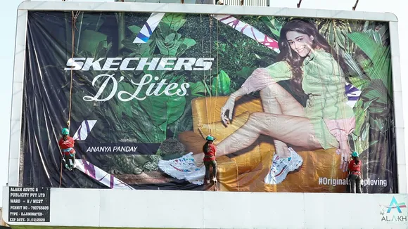 For the first time in India, a team of women install a flex for a Skechers billboard