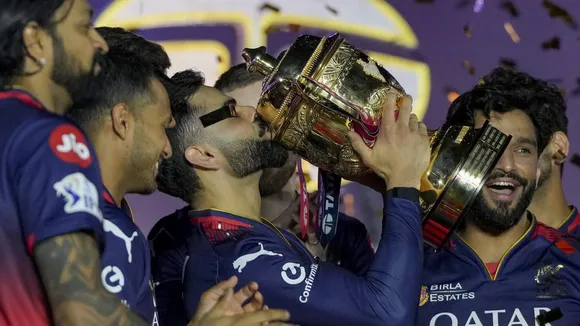 Virat Kohli kisses the IPL 2025 championship trophy at the Narendra Modi Stadium in Ahmedabad on Tuesday, June 3, 2025.
