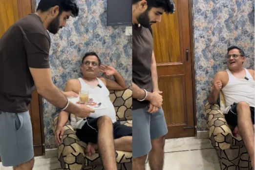 Son bringing tea to his father