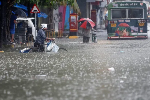 Bus conductor saves lives in heavy rainfall; rescued father-son clinging on the bus's wheel