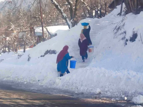 Women-collecting-water-from-a-running-stream-as-water-pipes-are-frozne-during-winters_11zon-1740887202 (1)
