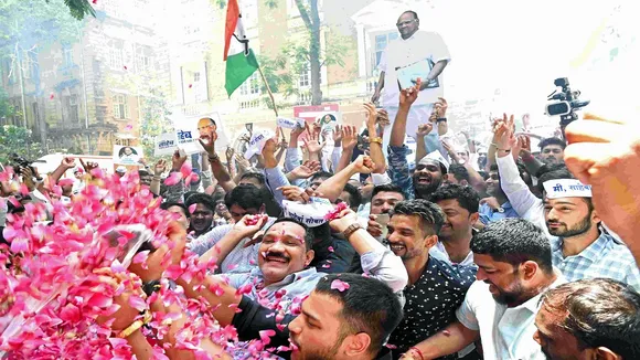 NCP supporters celebrate after party's core committee reject the resignation of Sharad Pawar as party president