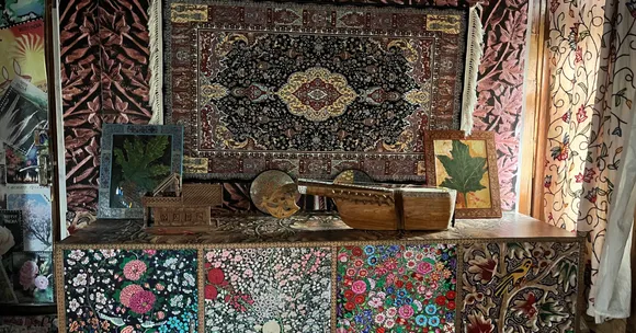 Rich carpets and carved walnut panels turn the floating post office into a living gallery of Kashmiri heritage.