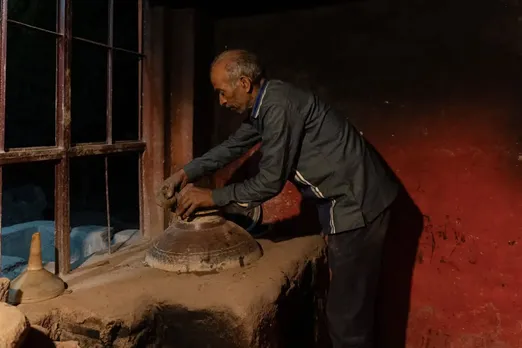 A traditional perfumer crafting fragrances in a ded babka