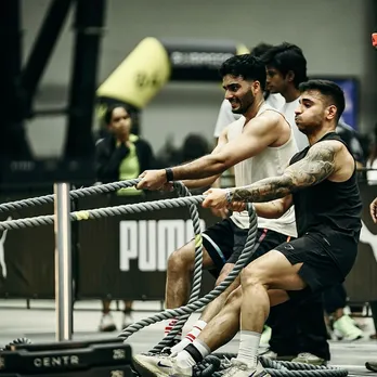 Participants at Hyrox India compete in a sled push challenge during a functional fitness race in Mumbai