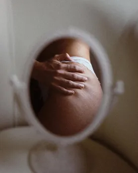 A picture via a table mirror of a woman's body suggesting the impact of endometriosis on sex life
