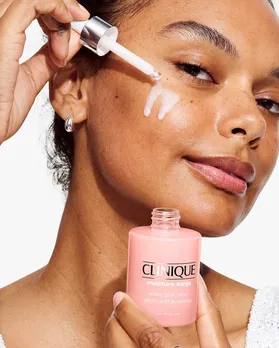 A woman applying a serum from Clinique on her sensitive skin