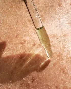 A pipette closer to the skin to apply hydrating serum on sensitive skin