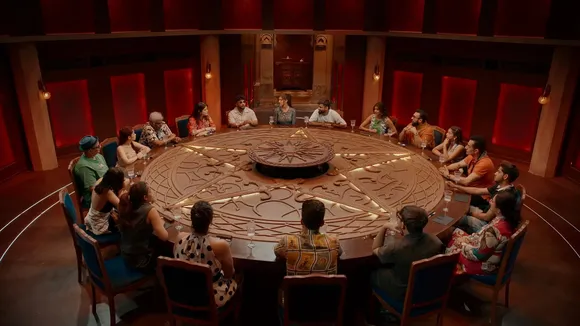 Participants of The Traitors, one of the most recent Indian reality shows gather around a table and play the game, thriving in the current reality TV culture thanks to OTT reality shows India