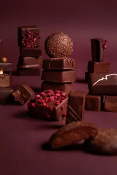 A tower of Indian bean-to-bar chocolate with flavours and fillings by Manam Chocolate, showing how artisanal chocolate in India is changing chocolate gifting in India and leading to a rise in homegrown chocolate brands
