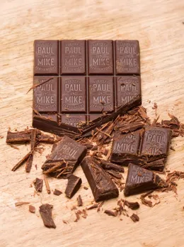 A half chopped up bar of dark chocolate by Paul and Mike to depict the growing popularity of homegrown chocolate brands making artisanal chocolate in India.