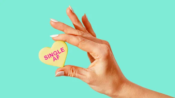 A hand holding a heart with 