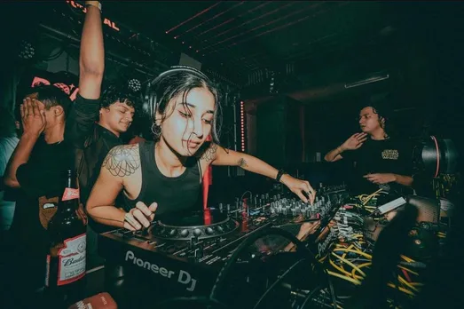A woman works her way with the DJ console to show how the increasing number of female DJs in India who are bringing about a change in the Indian DJ scene