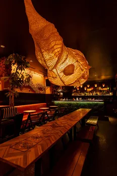 A bar with a huge paper lantern and dim, wooden, natural lighting to show how Izakaya bars in India are the next step in the evolution of Japanese cuisine in India