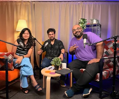 Three people--two hosts and a guest sit in a studio comprising mics and essentials to create some of the best podcasts in India, showing how attention to detail can make some of the must-listen Indian podcasts
