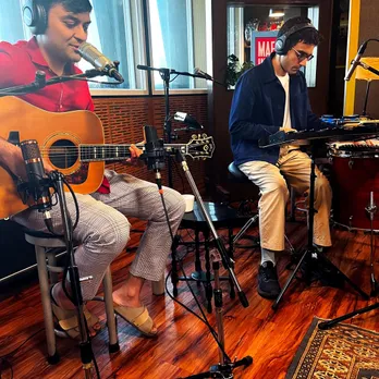 A still from a video podcast, where two musicians are performing with guitars, percussions and vocals, to show how interesting elements can make some the must-listen Indian podcasts.