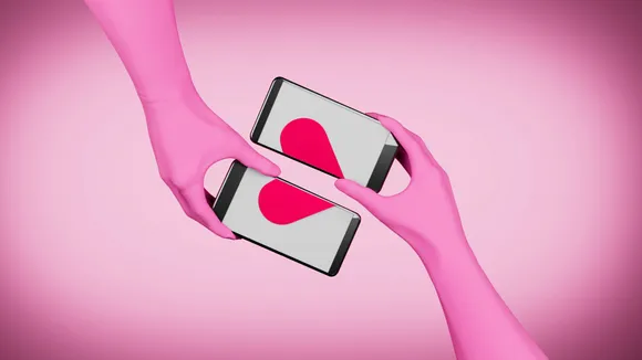 Two phones held by two different people with the screens drifting apart for form a broken heart to show the difficult in navigating political differences in dating and the importance of politics and dating in India.