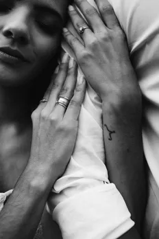 A woman wraps her hand around a man to indicate the intertwining of politics and relationships in India in 2025, and how Indians are navigating political differences in dating.