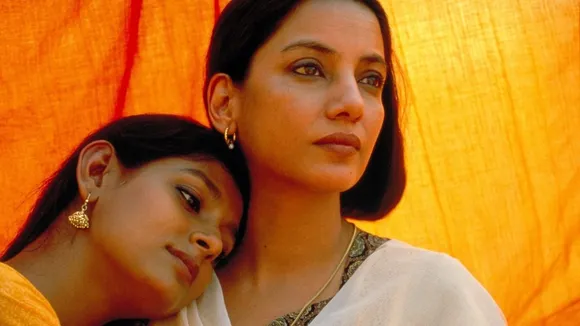 A still from a film with a zoomed in shot of two women holding each other, to depict the evolution of romantic films in India to include female desire in Bollywood