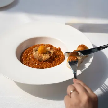 A picture of dal makhni being served in a fancy, elevated format to depict a dish that has impacted Punjabi food culture in India and been an emblem of Punjabi cuisine abroad