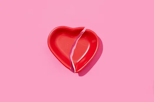 A picture of a ceramic broken red heart against a pink background to show how queer friendships after breakup thrive in the realm of queer dating in India