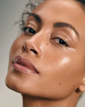 A zoomed-in shot of a woman's face, featuring glowing skin after using accessible products due to democratisation of beauty in India