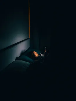 A woman looking for ChatGPT medical advice at night