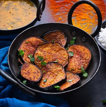 A picture of a dish full of baigun bhaja, a classic pat of Bengali traditional food also served in pice hotels across Kolkata, which boast of authentic Bengali food