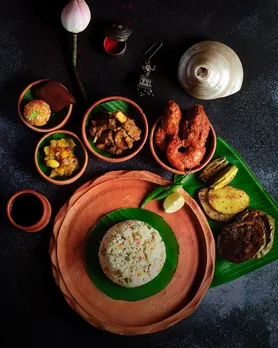 A spread of Bengali traditional food, including Ilish Paturi, Daab Chingri, Bhapa Ilish, Basanti Pulao, to signify offerings that go beyond bengali new year traditional food.