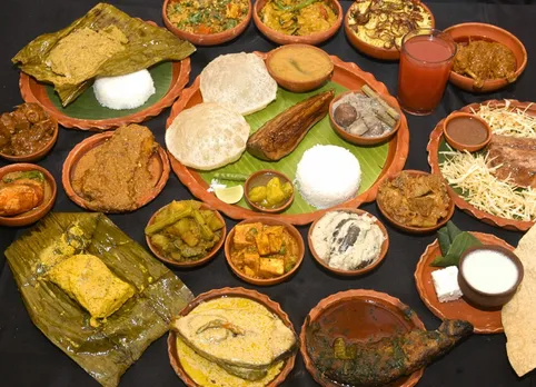 A spread of authentic Bengali food like Chitol Petir Jhal, Pabda Jhaal, Doi Begun, as well as those that count as bengali new year traditional food like Daab Chingri