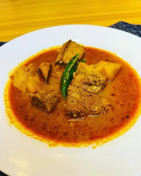 A mutton curry with a chilli on top to signify the classic Kosha Mangsho that is a Bengali traditional food that has gained popularity all over the country as authentic Bengali food