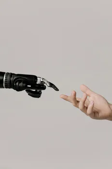 Hands of a human and robot, reflecting the rise of AI in healthcare