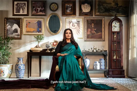 A still from Bombay Begums, with Pooja Bhatt sitting a room with the words 'yeh toh khaa jati hai' being used to describe her to show how sexist language and sexism in language persists even today, and how women who use offensive language are judged