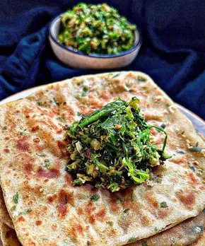 A picture of a huge bread with green thecha on it to depict the diversity of Indian condiments particularly regional Indian condiments and traditional Indian condiments
